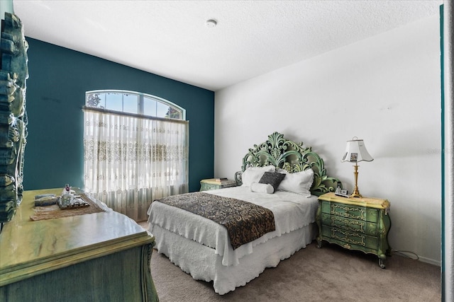 carpeted bedroom with a textured ceiling