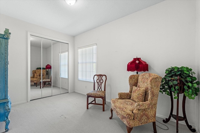 sitting room with carpet and baseboards