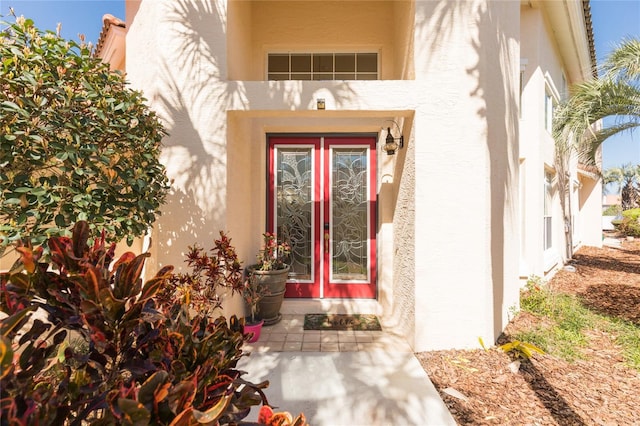 property entrance with stucco siding