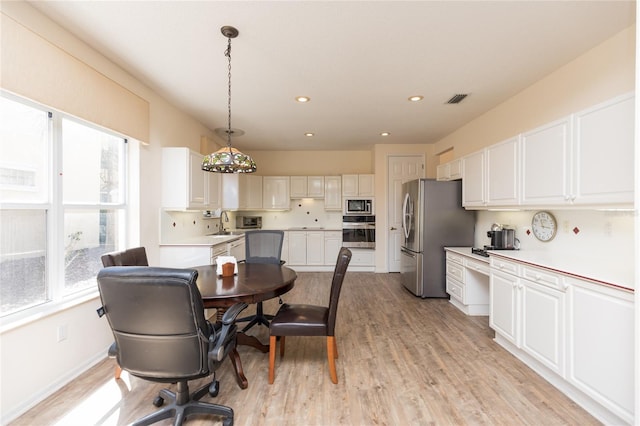 dining space featuring recessed lighting, visible vents, and light wood finished floors