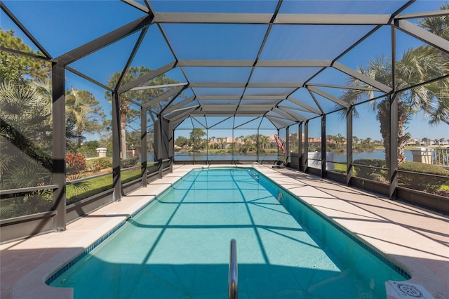 outdoor pool with a lanai, a water view, and a patio