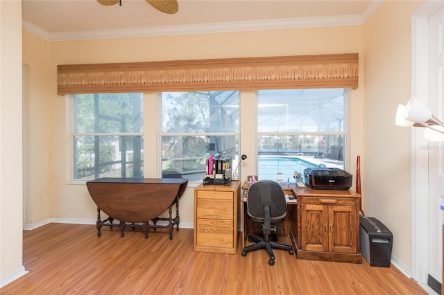 home office with a sunroom, baseboards, light wood finished floors, and ornamental molding