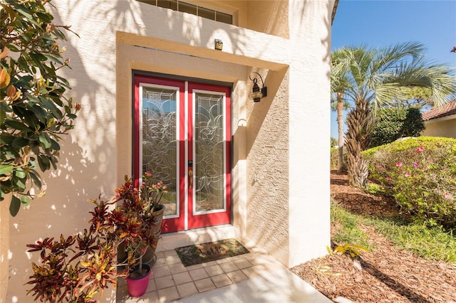 entrance to property with stucco siding