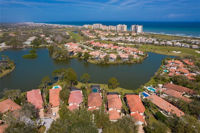 drone / aerial view featuring a residential view and a water view