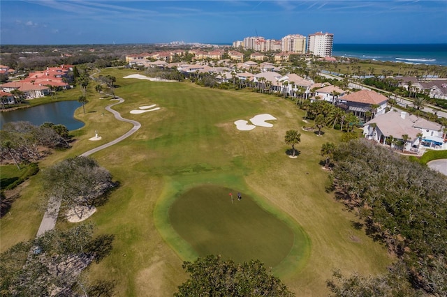 birds eye view of property featuring view of golf course and a water view