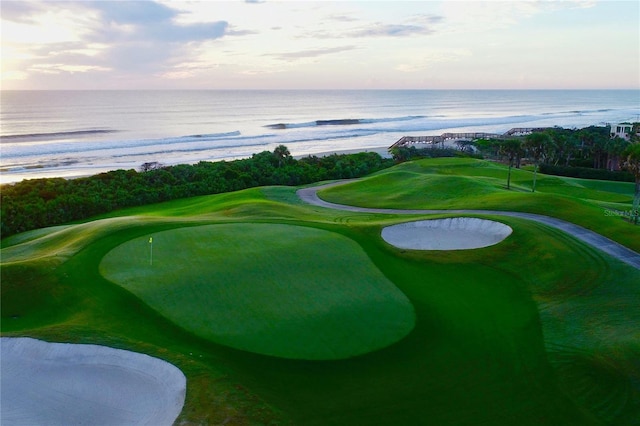 view of community with golf course view and a water view