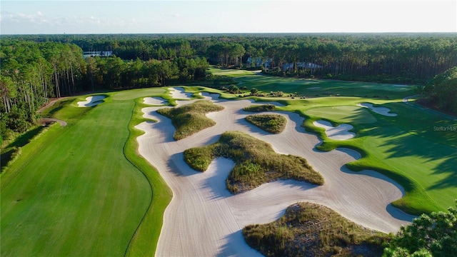 bird's eye view with golf course view and a forest view