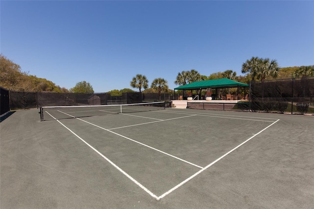 view of sport court featuring fence