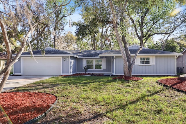 ranch-style house with a front lawn, central AC, board and batten siding, concrete driveway, and an attached garage