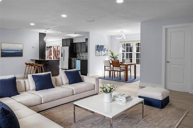 living area featuring recessed lighting and light wood-type flooring