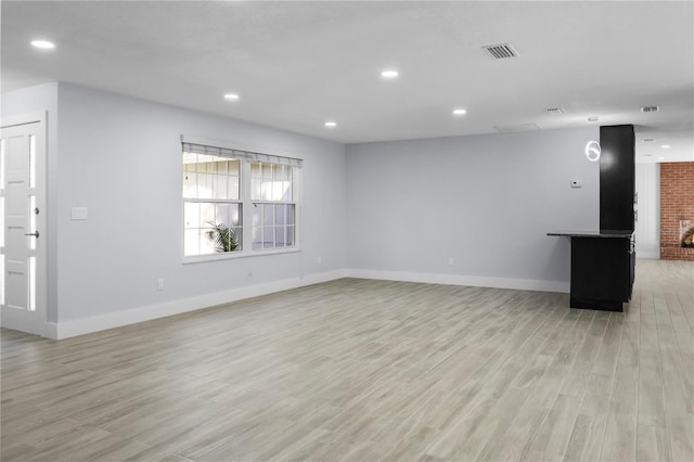 unfurnished living room with light wood-style flooring, recessed lighting, visible vents, and baseboards