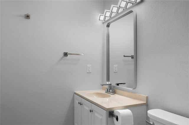 bathroom with toilet and vanity