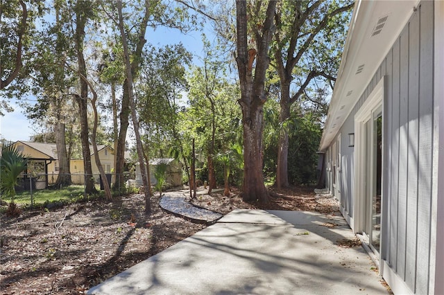 view of yard with a patio, fence, and visible vents