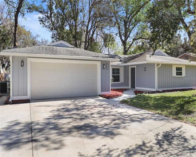 1011 Indian Oaks W, Daytona Beach, FL 32117 - ranch-style home with concrete driveway, an attached garage, and roof with shingles