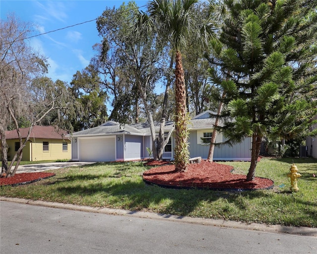 ranch-style home with a garage, concrete driveway, and a front lawn