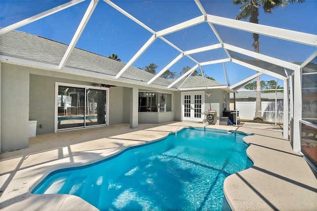 view of pool with a patio, french doors, glass enclosure, a fenced in pool, and ceiling fan