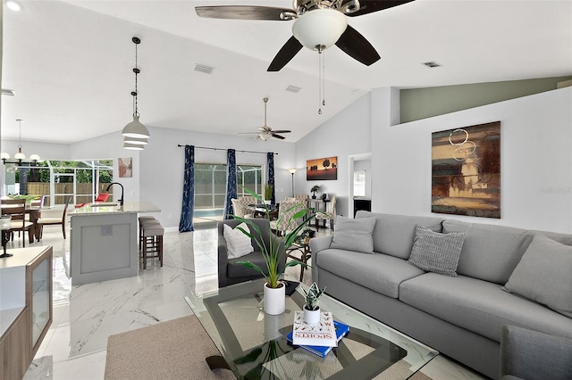 living room with visible vents, high vaulted ceiling, marble finish floor, and an inviting chandelier