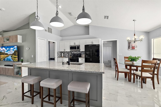 kitchen with visible vents, a sink, black appliances, white cabinetry, and marble finish floor