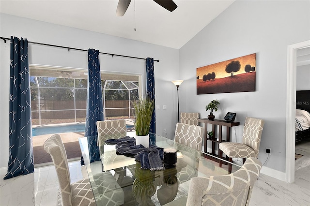 dining room with a ceiling fan, vaulted ceiling, baseboards, and marble finish floor