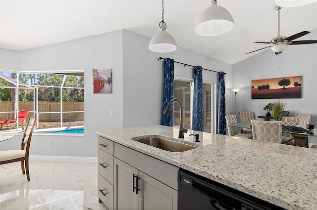 kitchen with light stone counters, baseboards, a sink, hanging light fixtures, and marble finish floor