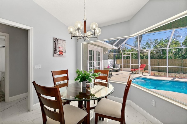 dining room with baseboards, an inviting chandelier, lofted ceiling, a sunroom, and marble finish floor