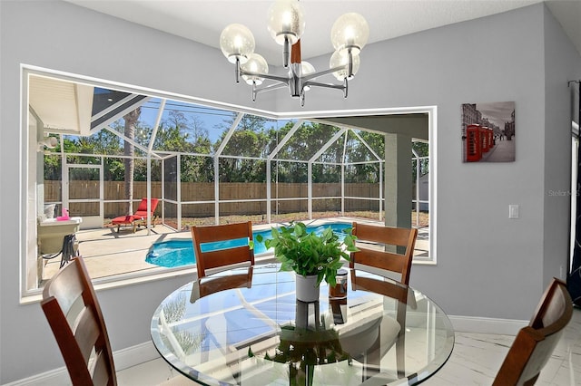 dining room featuring marble finish floor, baseboards, and a sunroom