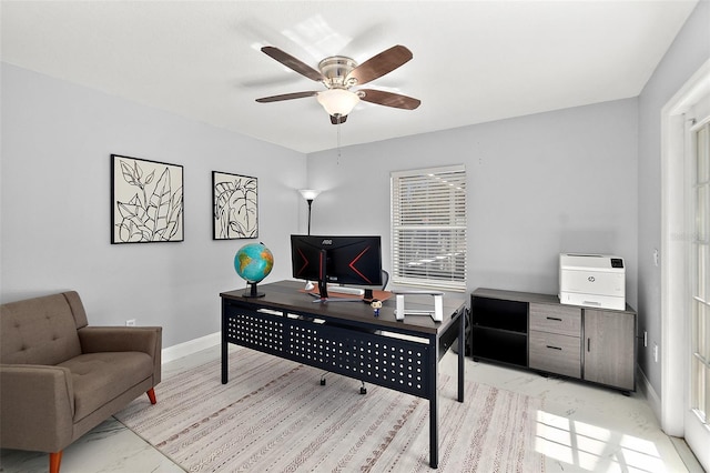 office space with baseboards, marble finish floor, and ceiling fan