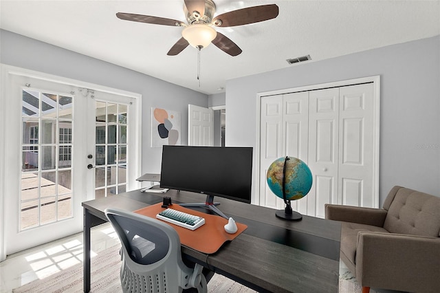 office featuring french doors, visible vents, wood finished floors, and a ceiling fan