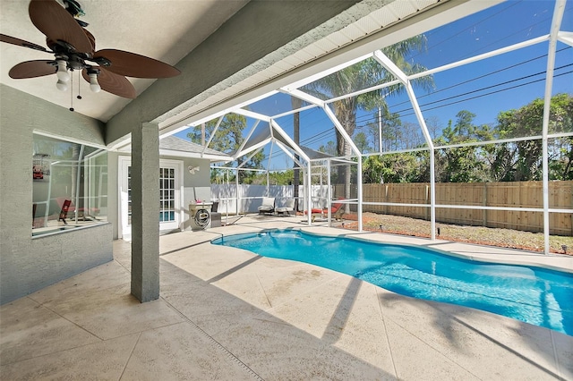 view of pool with a patio area, ceiling fan, a lanai, and a fenced backyard