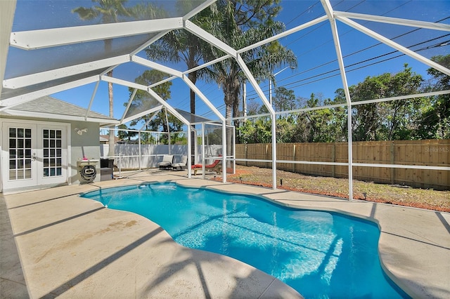 view of pool featuring french doors, a fenced in pool, a fenced backyard, and a patio area