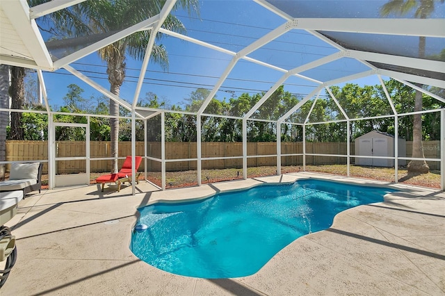 view of swimming pool featuring an outbuilding, a shed, a fenced backyard, a lanai, and a patio area