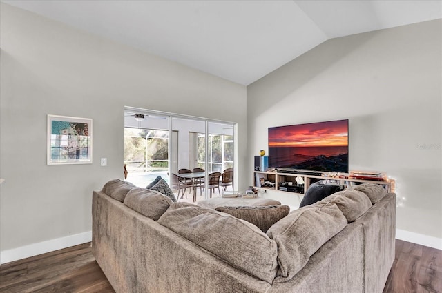 living room with baseboards, lofted ceiling, and wood finished floors