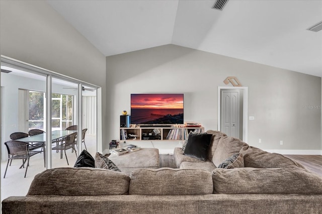 living room with lofted ceiling, baseboards, and visible vents