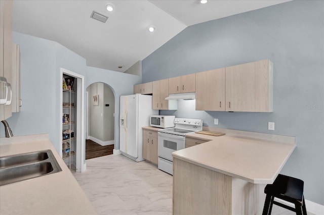 kitchen with marble finish floor, light brown cabinets, white appliances, arched walkways, and light countertops