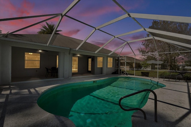 pool featuring glass enclosure and a patio