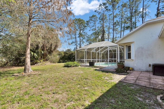 view of yard with glass enclosure and an outdoor pool