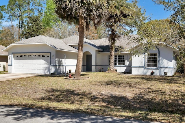 single story home with stucco siding, a garage, and driveway