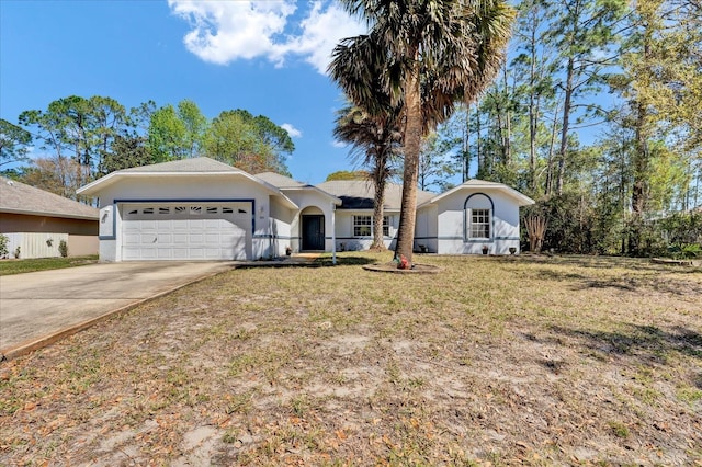 single story home featuring concrete driveway, an attached garage, a front yard, and stucco siding