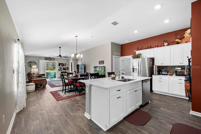 kitchen with visible vents, open floor plan, ceiling fan with notable chandelier, stainless steel appliances, and a sink