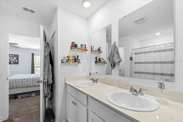 full bath with a sink, visible vents, and ensuite bathroom