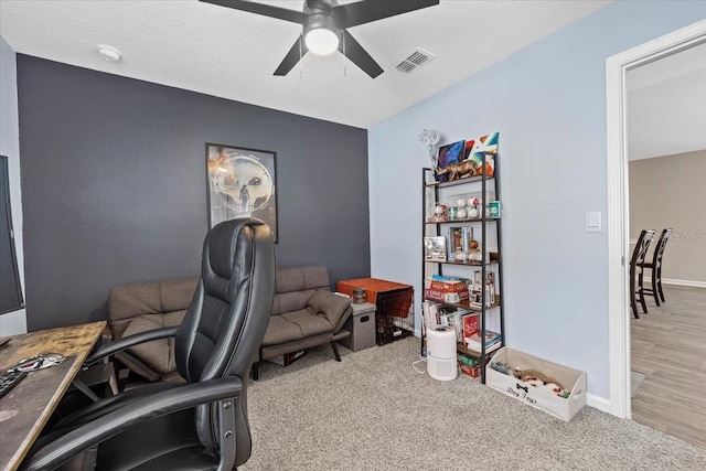 home office with visible vents, baseboards, carpet, and a ceiling fan