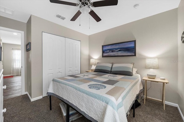 carpeted bedroom featuring a closet, visible vents, a ceiling fan, and baseboards