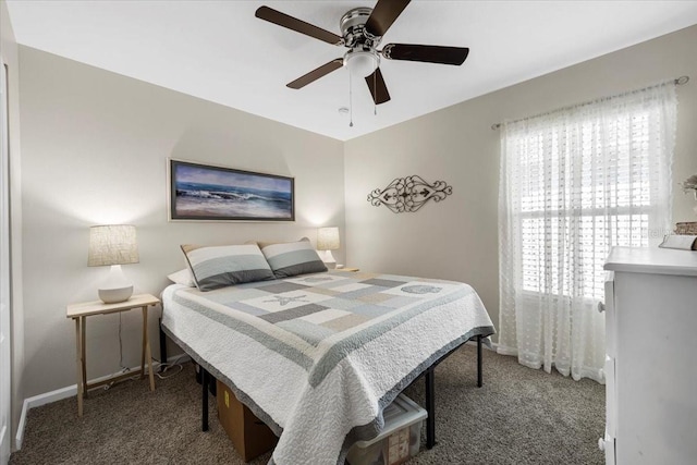 carpeted bedroom featuring baseboards and a ceiling fan