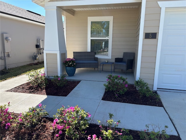 property entrance featuring a porch and a garage