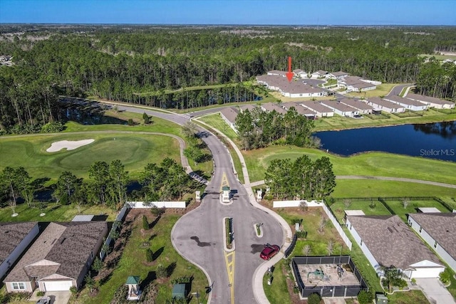 drone / aerial view featuring a forest view, a water view, and golf course view