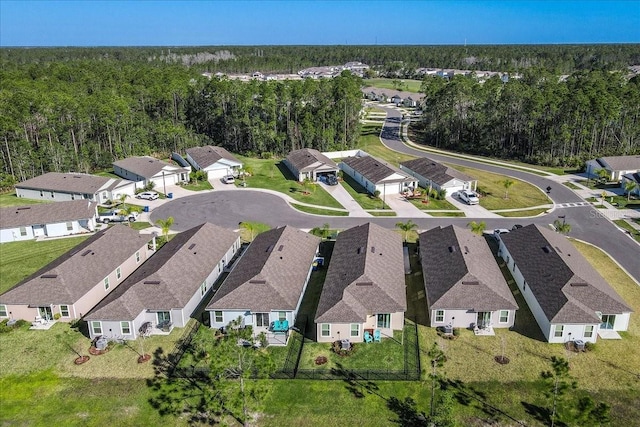 bird's eye view featuring a view of trees and a residential view