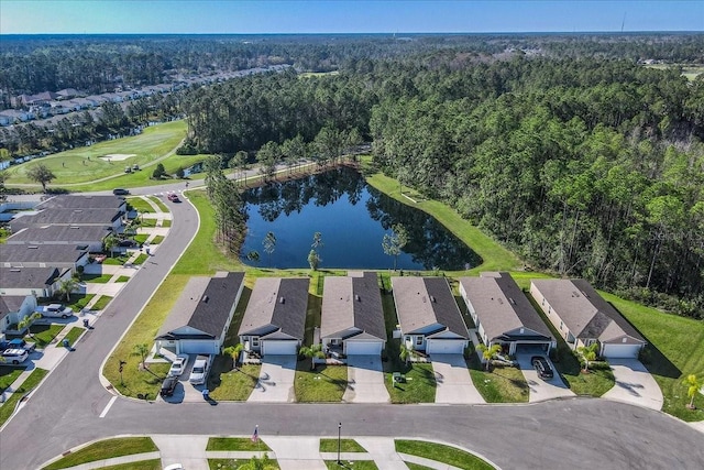 drone / aerial view with a water view, a wooded view, and a residential view