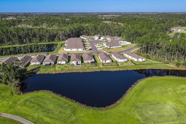 aerial view featuring a residential view, a wooded view, and a water view