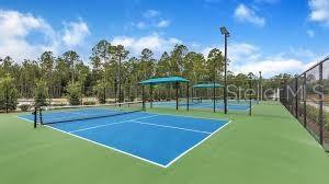 view of tennis court with community basketball court and fence