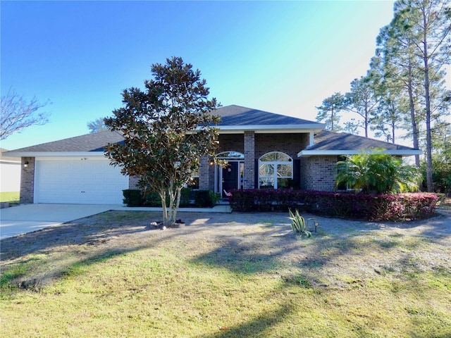 ranch-style home featuring a front lawn, brick siding, concrete driveway, and an attached garage